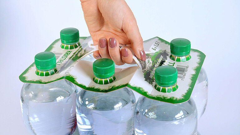 PET bottles with cardboard carry handle