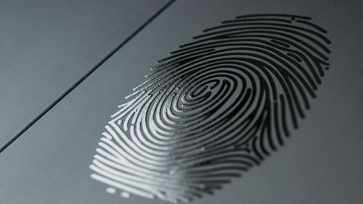 Black glossy fingerprint on black cardboard
